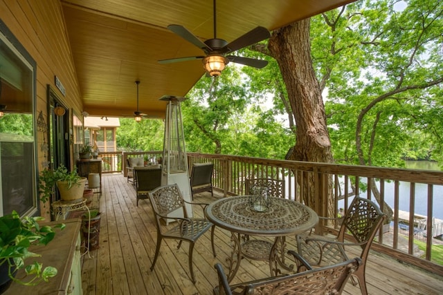 deck featuring a water view and ceiling fan