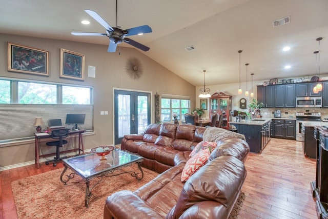 living room featuring french doors, visible vents, and light wood finished floors