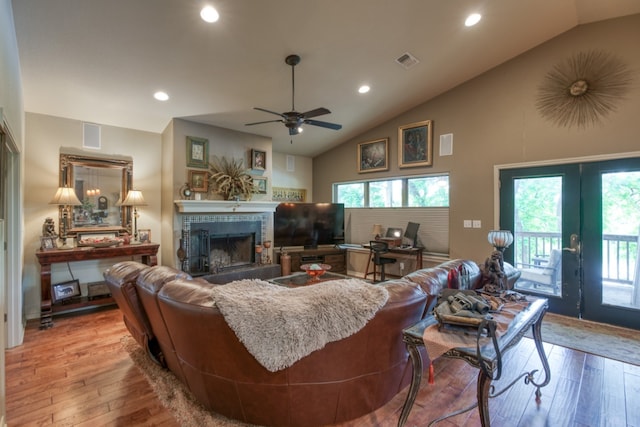 living room with visible vents, plenty of natural light, light wood-style flooring, and a fireplace