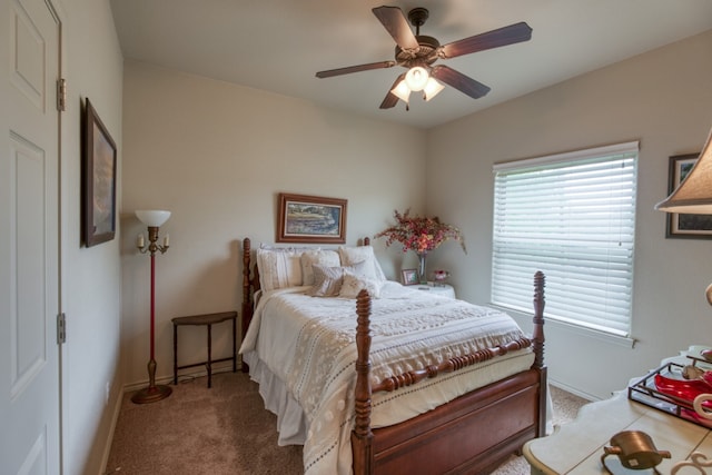 bedroom with a ceiling fan, carpet flooring, and baseboards