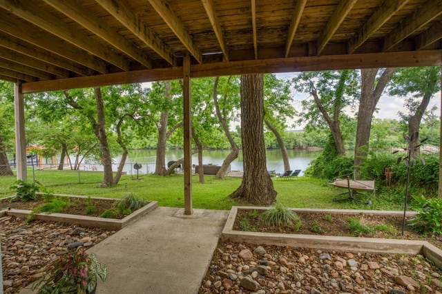 exterior space with a water view and a lawn