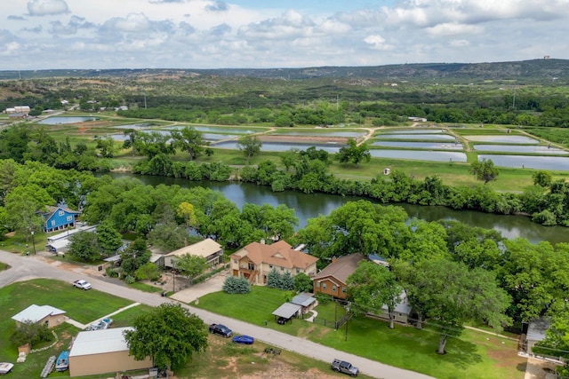 drone / aerial view featuring a residential view and a water view