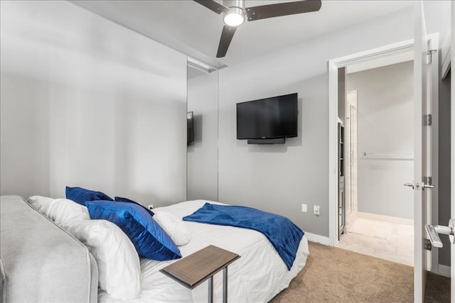 carpeted bedroom with attic access, ceiling fan, and baseboards