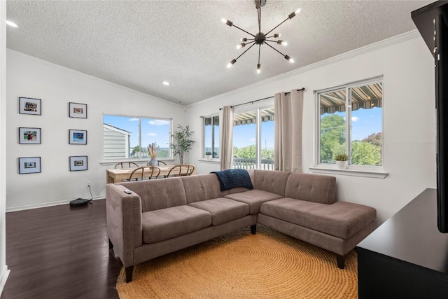 living area featuring a notable chandelier, ornamental molding, vaulted ceiling, a textured ceiling, and wood finished floors