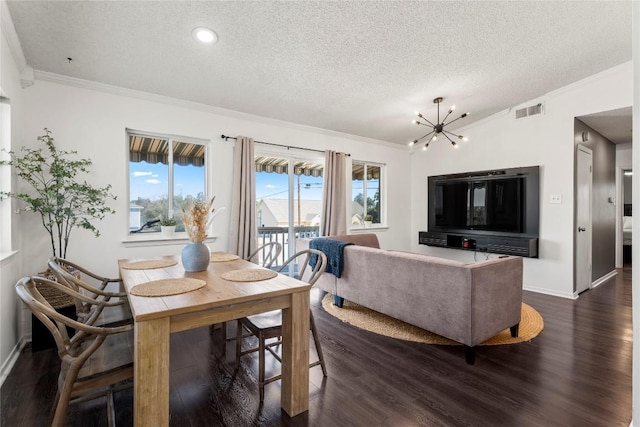 dining area featuring crown molding, visible vents, dark wood finished floors, and a textured ceiling