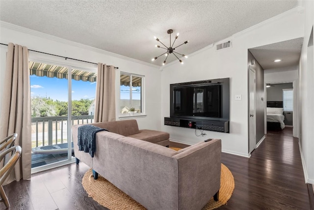 living area with a notable chandelier, dark wood finished floors, visible vents, and crown molding