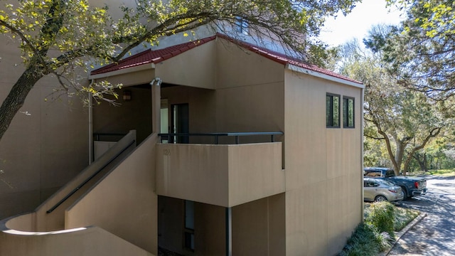 view of side of home with a tiled roof