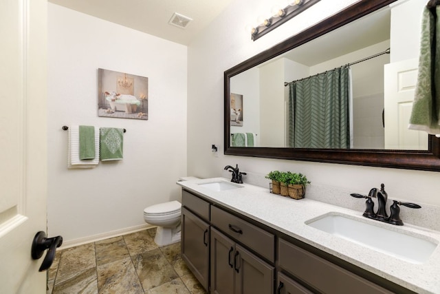 full bath featuring toilet, double vanity, a sink, and visible vents