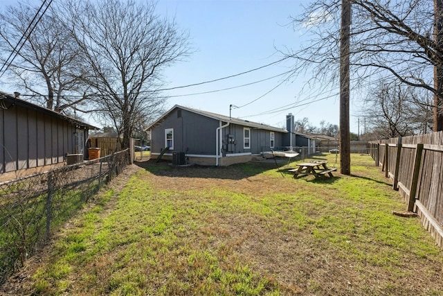 view of yard featuring a fenced backyard and central air condition unit