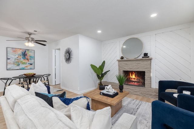 living room featuring a fireplace, recessed lighting, visible vents, wood finished floors, and baseboards