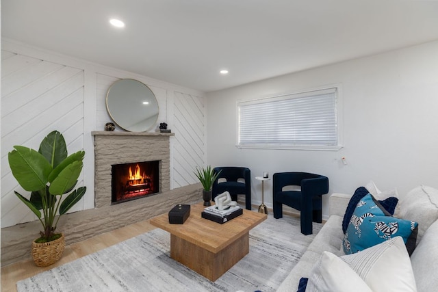 living area featuring a fireplace, wood finished floors, and recessed lighting