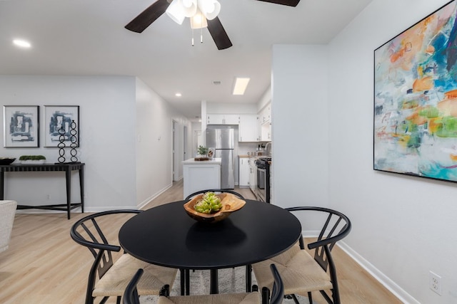 dining area with light wood finished floors, ceiling fan, baseboards, and recessed lighting