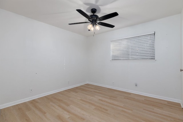 unfurnished room with baseboards, a ceiling fan, and light wood-style floors