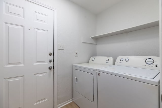 laundry room featuring laundry area, baseboards, independent washer and dryer, and light wood finished floors