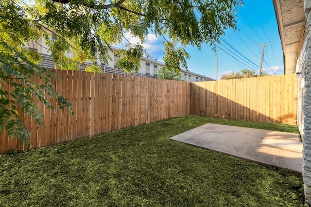 view of yard with a patio area and a fenced backyard