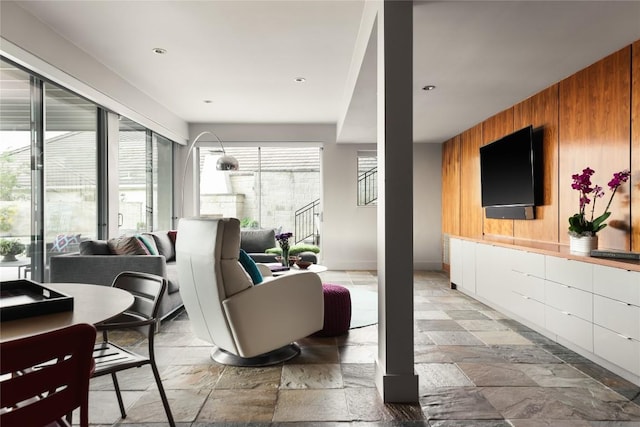 719 Cutlass St, Austin, TX 78734 - living area with stone tile flooring, wood walls, and recessed lighting