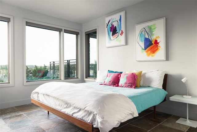 719 Cutlass St, Austin, TX 78734 - bedroom with multiple windows and stone tile floors