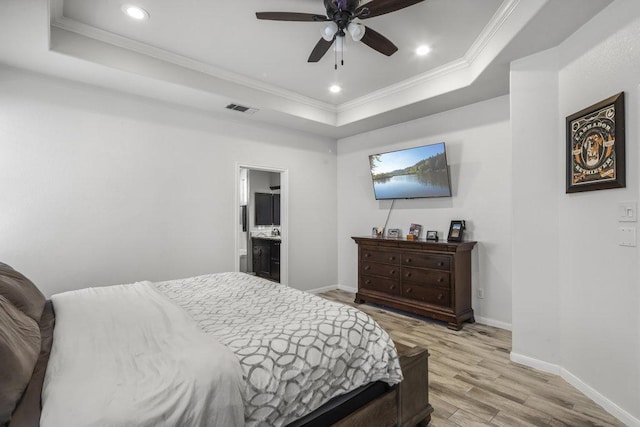 bedroom with visible vents, a raised ceiling, and ornamental molding