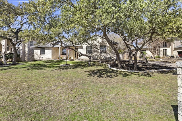 view of front of home with stone siding and a front yard