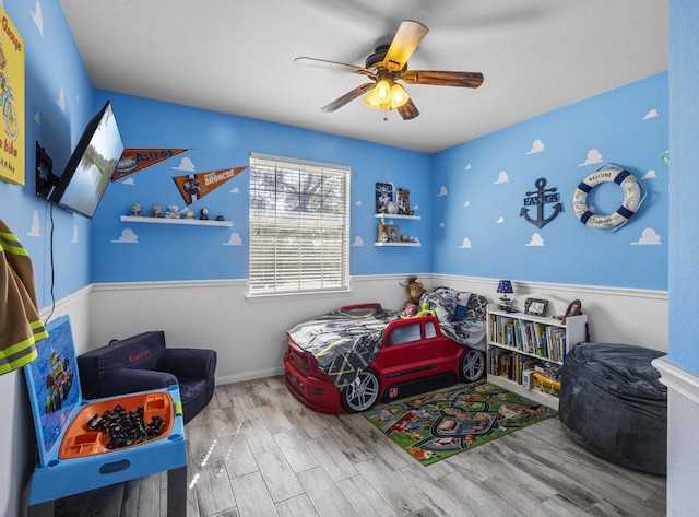 bedroom with wood finished floors and a ceiling fan