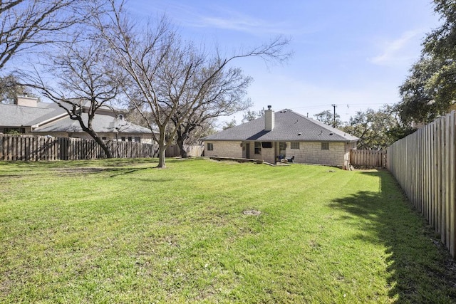 view of yard with a fenced backyard