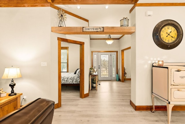 entryway with light wood finished floors, baseboards, and beam ceiling