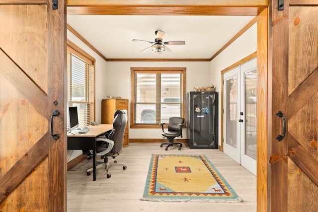 office space with ornamental molding, french doors, and a barn door