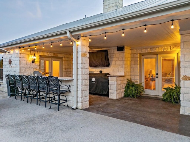 view of patio / terrace with french doors, outdoor dry bar, and area for grilling