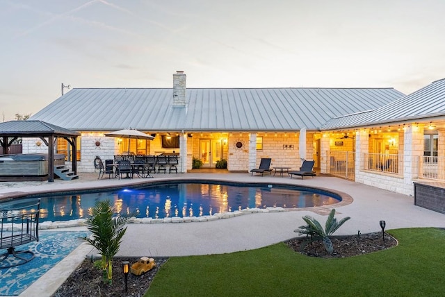 pool featuring a gazebo, a patio, fence, and a hot tub