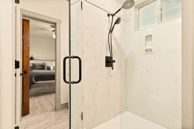 full bathroom with connected bathroom, a marble finish shower, and wood finished floors