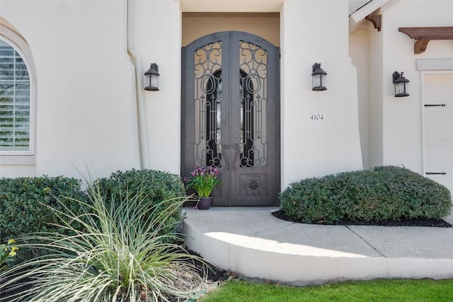 4104 Belisario Ct, Leander, TX 78641 - view of exterior entry featuring french doors, stucco siding, and a garage