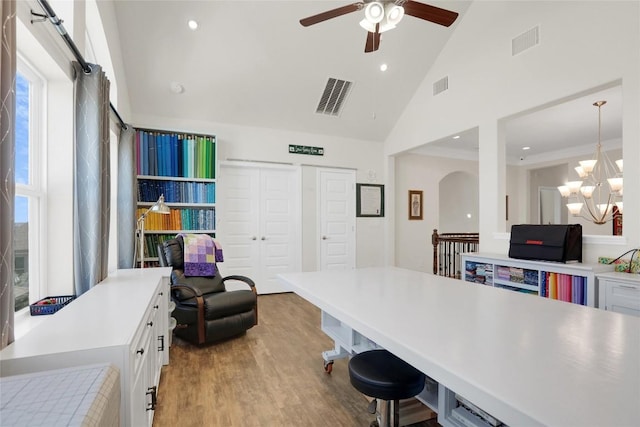 4104 Belisario Ct, Leander, TX 78641 - home office with high vaulted ceiling, a ceiling fan, wood finished floors, a chandelier, and plenty of natural light