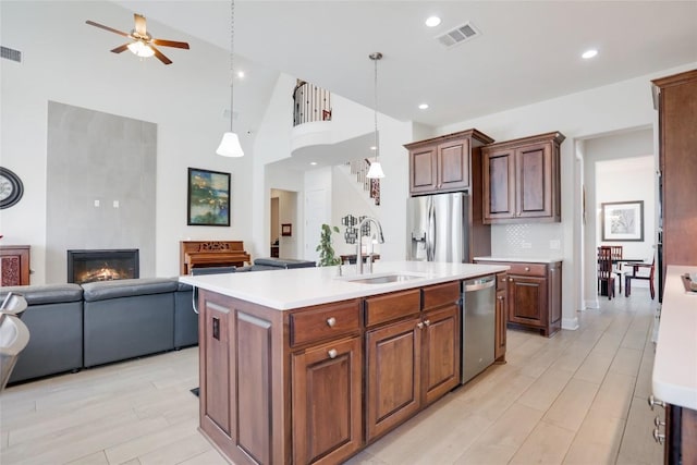 4104 Belisario Ct, Leander, TX 78641 - kitchen featuring stainless steel appliances, open floor plan, ceiling fan, light countertops, and decorative backsplash