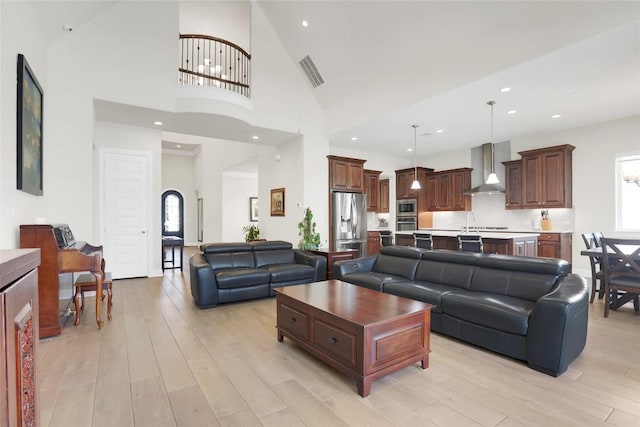 4104 Belisario Ct, Leander, TX 78641 - living area featuring light wood-style floors, healthy amount of natural light, and a high ceiling