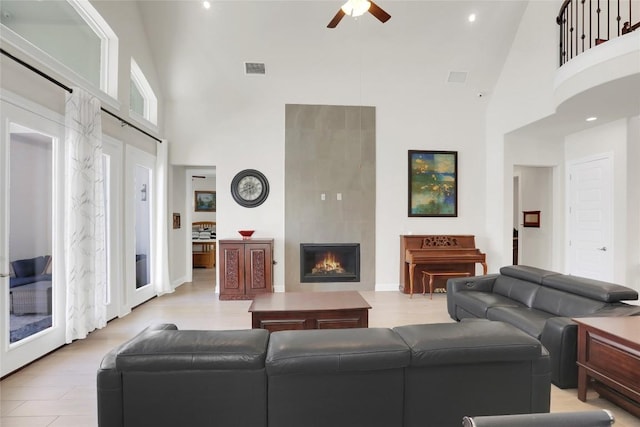 4104 Belisario Ct, Leander, TX 78641 - living area featuring a high ceiling, a ceiling fan, a warm lit fireplace, and recessed lighting