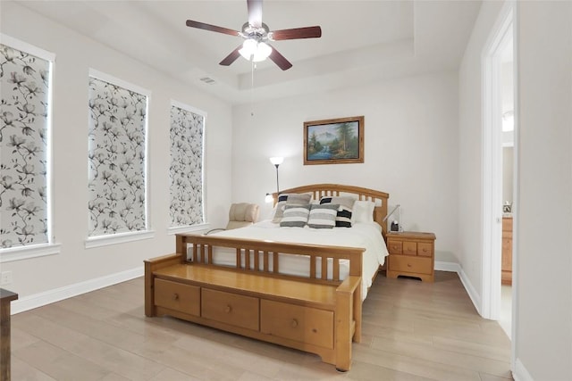 4104 Belisario Ct, Leander, TX 78641 - bedroom featuring light wood-type flooring, a raised ceiling, and ceiling fan