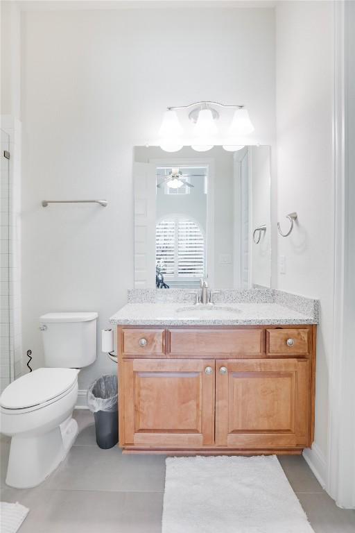 4104 Belisario Ct, Leander, TX 78641 - bathroom featuring vanity, ceiling fan, tiled shower, and tile patterned flooring