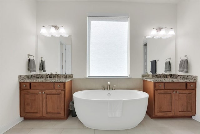 4104 Belisario Ct, Leander, TX 78641 - bathroom featuring a freestanding tub, two vanities, and tile patterned floors