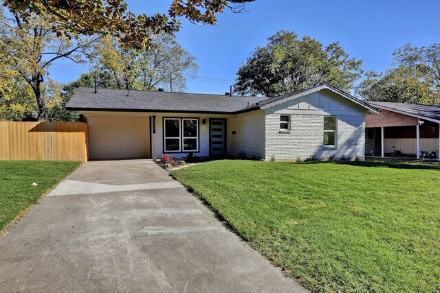 1520 Weyford Dr, Austin, TX 78757 - view of front of home featuring driveway, an attached carport, brick siding, and board and batten siding
