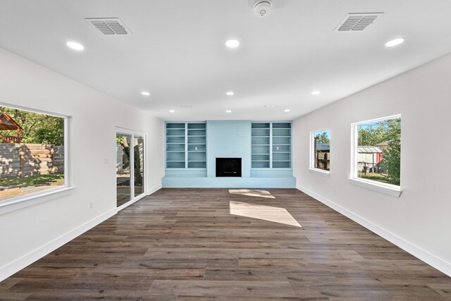 1520 Weyford Dr, Austin, TX 78757 - unfurnished living room featuring plenty of natural light, a fireplace, recessed lighting, and dark wood finished floors