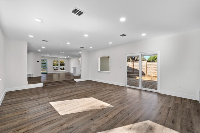 1520 Weyford Dr, Austin, TX 78757 - unfurnished living room with wood finished floors, plenty of natural light, and recessed lighting