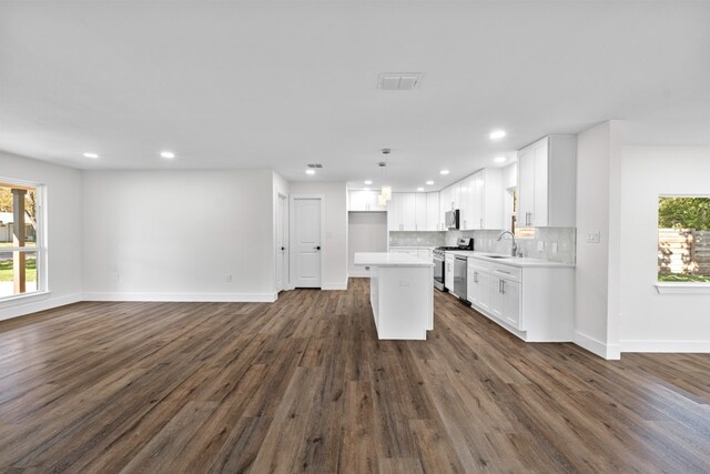 1520 Weyford Dr, Austin, TX 78757 - kitchen featuring stainless steel range oven, open floor plan, recessed lighting, white cabinetry, and light countertops