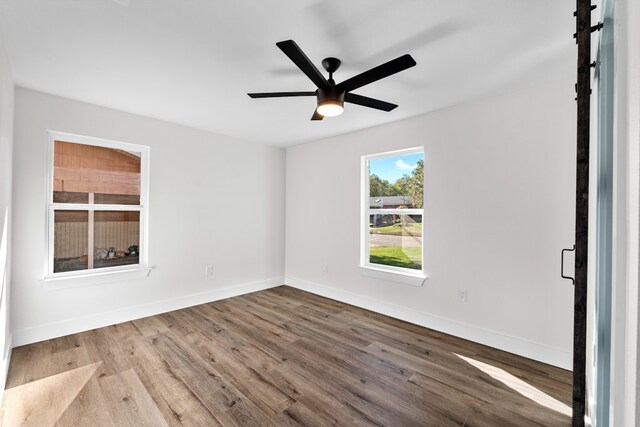 1520 Weyford Dr, Austin, TX 78757 - empty room with wood finished floors and a ceiling fan