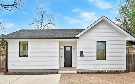 single story home with fence and roof with shingles