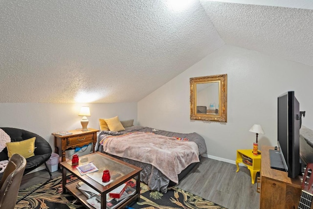 2210 Pearl St Unit 305, Austin, TX 78705 - bedroom with a textured ceiling, wood finished floors, and lofted ceiling