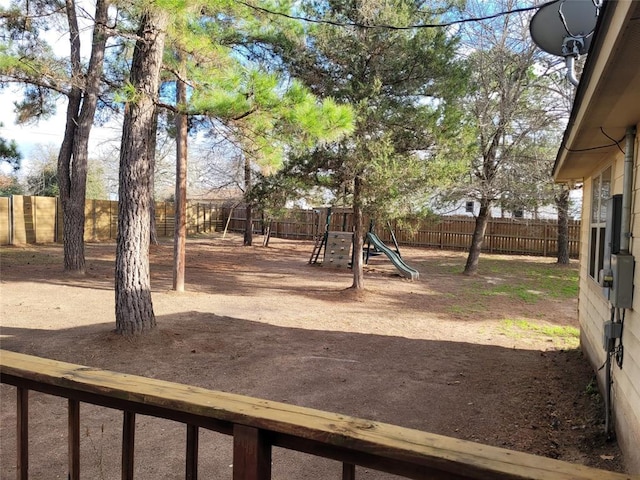 view of yard with playground community and a fenced backyard