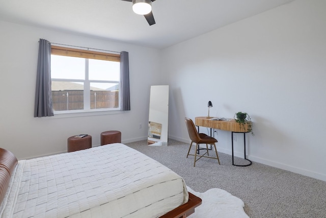 carpeted bedroom with ceiling fan and baseboards