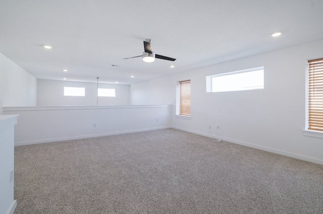 empty room with recessed lighting, carpet flooring, a wealth of natural light, and baseboards