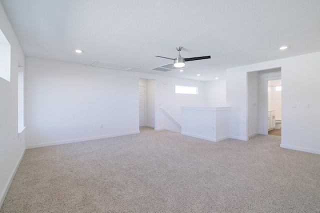 empty room with a ceiling fan, recessed lighting, light carpet, and baseboards