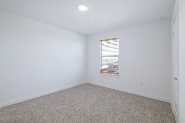 carpeted empty room with baseboards